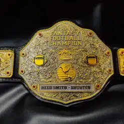 Close-up of the FFL Championship Belt featuring intricate gold engraving, customizable side plates, and red gemstone detailing.