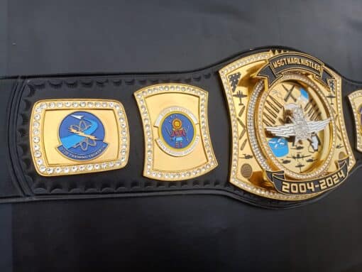 Championship belt with custom military logos, celebrating honorary achievements.