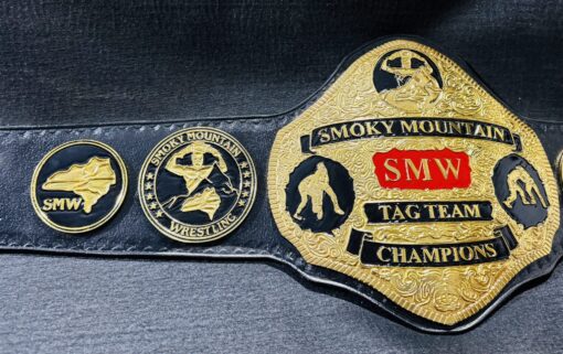 A pristine SMW Tag Team Wrestling Belt, with intricate etching and bold championship symbols representing tag team legacy.