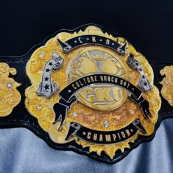 Detailed view of HD engraving on a premium corporate championship belt with gold and chrome finish.