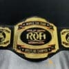 ROH Tag Team Title Belt showcasing its shiny gold-plated surface