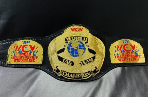 Authentic WCW World Tag Team Championship Belt replica, showcasing shiny gold plates and leather strap.