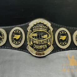 : Front view of the Southern Heavyweight Championship Belt showcasing the deep etching plates and shiny gold finish.