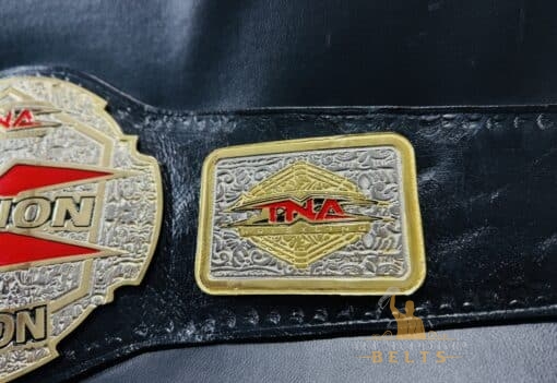 The TNA X Division Championship Belt featuring the official event logo, emphasizing its connection to TNA history.