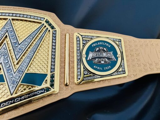 Close-up of the WrestleMania 40 logo on the Golden Championship Belt, showcasing the event's iconic branding.