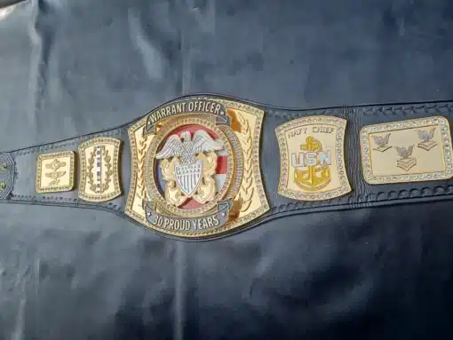 Full view of the Warrant Officer Championship Belt with leather strap and gold plates.