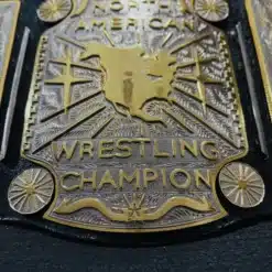 Close-up showing the precision of 5mm thick deep hand-engraved plates on the Mid South North American Heavyweight Title.