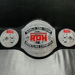 Close-up of the ROH Championship Belt showcasing detailed engravings and gold plating.