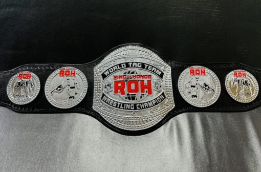 Close-up of the ROH Championship Belt showcasing detailed engravings and gold plating.