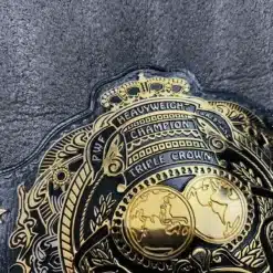 Close-up of the intricate engraving on the Triple Crown Wrestling Championship Belt.