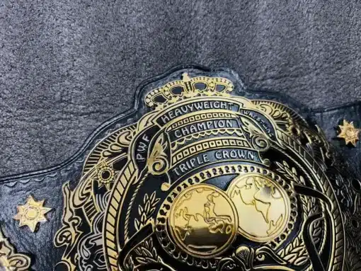 Close-up of the intricate engraving on the Triple Crown Wrestling Championship Belt.