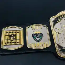 Side plate close-up showing football field engraving and league championship graphics on custom trophy belt