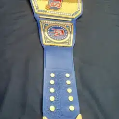 Championship belt featuring a blue leather strap with gold accents and crystals.