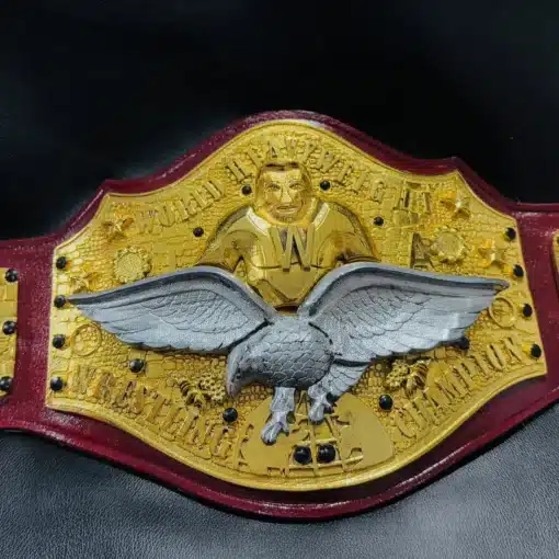 Classic World Heavyweight Wrestling Championship Belt with gold-plated plates, silver eagle centerpiece, and red leather strap.