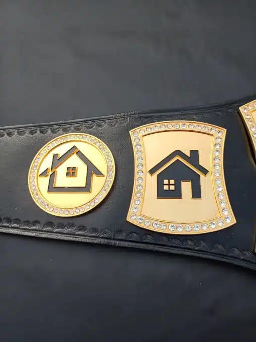 Engraved gold-plated side plates featuring a house logo on a custom real estate championship belt for realtors and brokers.