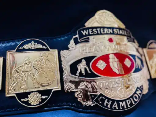 A side-angle shot of the NWA Western States Heavyweight Wrestling Belt, showing its deep etching and curved plates.