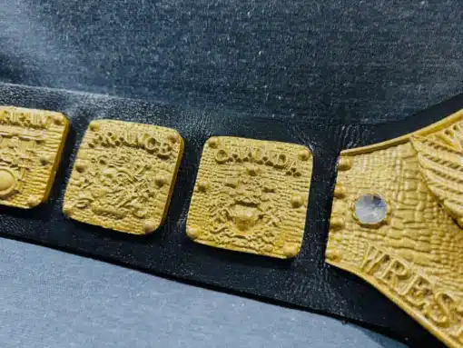 Die-cast WWWF Heavyweight Title belt with gold-plated eagle and side plate designs, a premium replica of 1970s wrestling history.