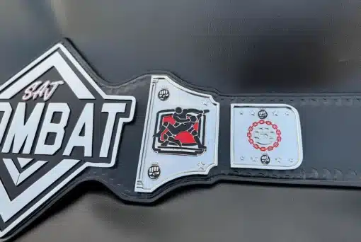 Engraved MMA fighters in action on the SAJ Combat Belt side plate, representing combat sports excellence.