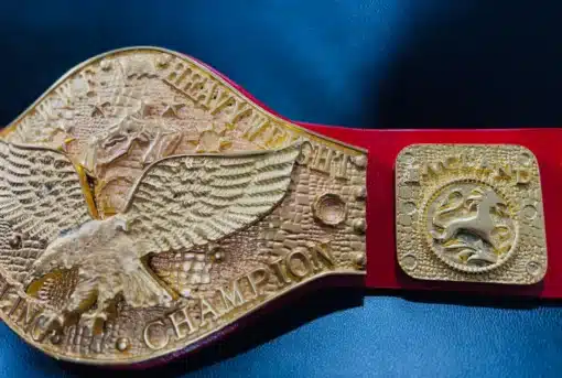 ide-angled view of the World Heavyweight Wrestling Championship Belt, emphasizing the eagle centerpiece and golden finish.