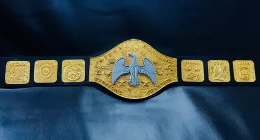 Close-up view of the NWA Canadian Heavyweight Championship belt’s center plate with intricate gold etching and an eagle emblem.