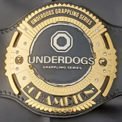 Close-up view of the Underdogs Grappling Series Championship Belt with gold-plated zinc etching