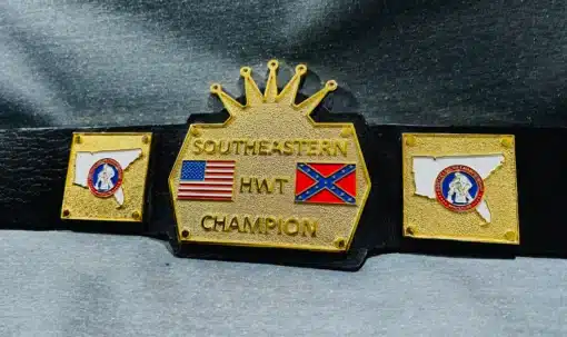 A close-up of the gold-plated main plate with "Southeastern HWT Champion" engraving and dual flag design.