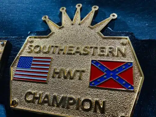 Angled view of the Southeastern Championship Belt, showing its gold-plated plates and deep HD engraving.