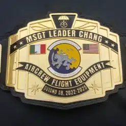Custom military belt for aircrew recognition with engraved gold plates and squadron insignia.