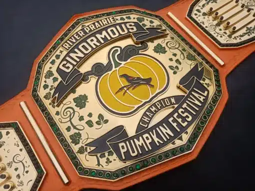 Close-up view of the 24K gold-plated Pumpkin Festival Champion Belt with engraved pumpkin design and Swarovski gems.