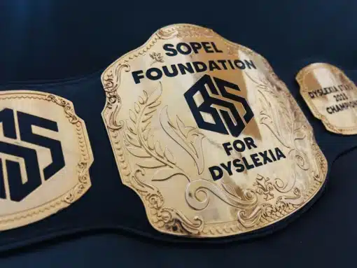 Detailed view of deep gold engraving on custom recognition belt for award ceremonies