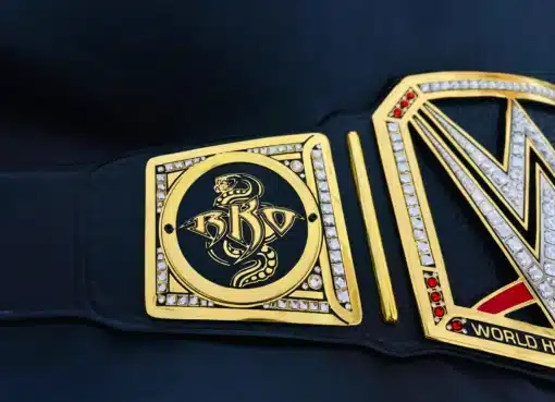 Detailed close-up of RKO snake logo on WWE replica belt side plate with gem border