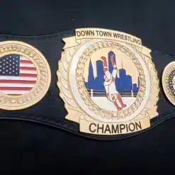 Octagonal main plate of wrestling belt showcasing engraved city skyline and in-ring action figure