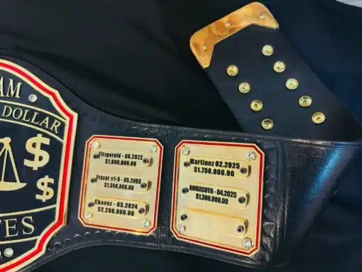 Law firm award belt featuring engraved brass plates and scales of justice design for recognizing big wins.