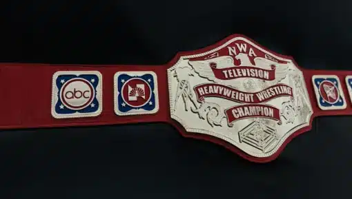 Angled photo of full NWA Television Championship belt on red strap.