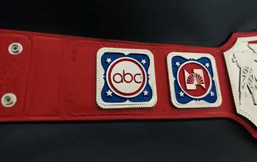 Close-up of ABC side plate with red hand-tooled strap texture.