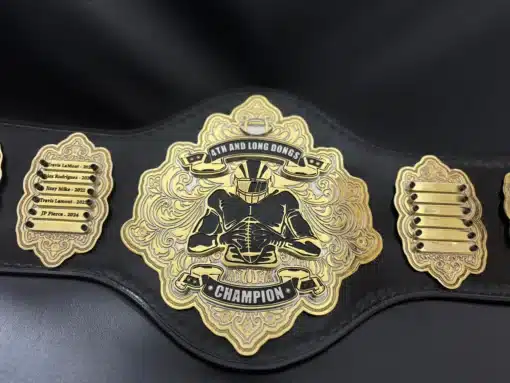 Deep HD-engraved fantasy football belt with intricate gold pattern and removable name panels