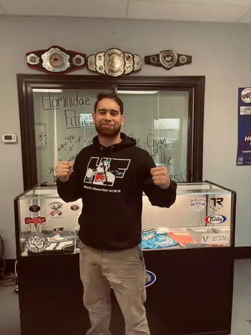 Martial arts fighter posing with custom title belt