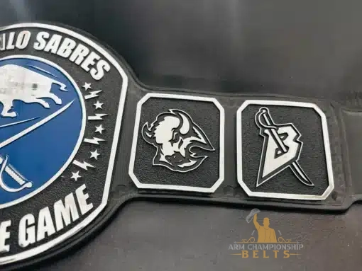 Side plate detail of Player of the Game belt with sword “B” and buffalo logo