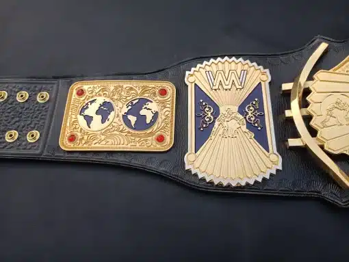 Close-up of dual globe side plates and wrestler emblem in deep gold on custom wrestling belt