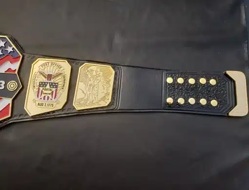 Black leather strap with snap closure on custom postal service honor championship belt