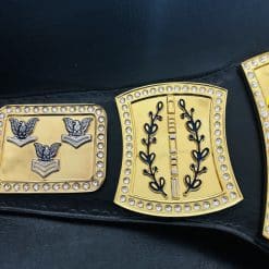 Detailed side plates on custom Navy retirement belt displaying military rank-style insignia with gold plating and crystal accents.