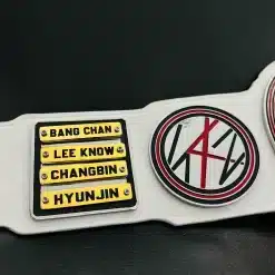 Custom championship belt featuring removable gold name plates designed for artists and fan club members